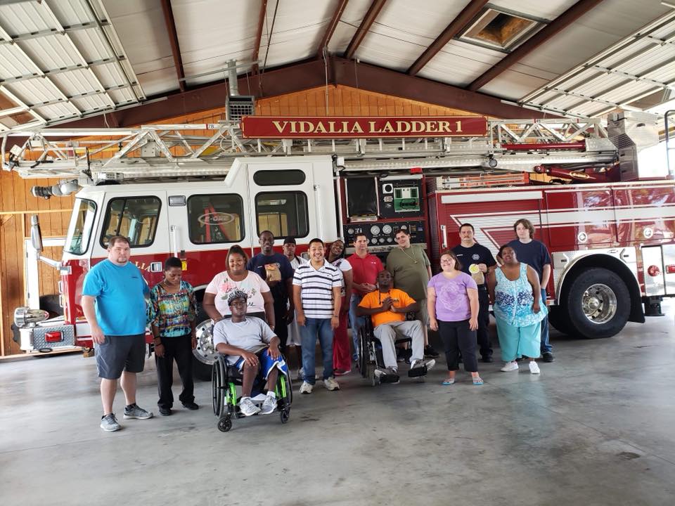 Southern Choices individuals and staff on a community outing at the fire station